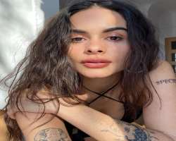 She has an elephant tattoo on her right arm along with two or three more various tattoos.